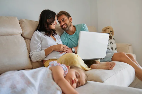 Happy Man Caressing Tummy Pregnant Woman Netbook Sitting Sofa Napping — Stock Photo, Image