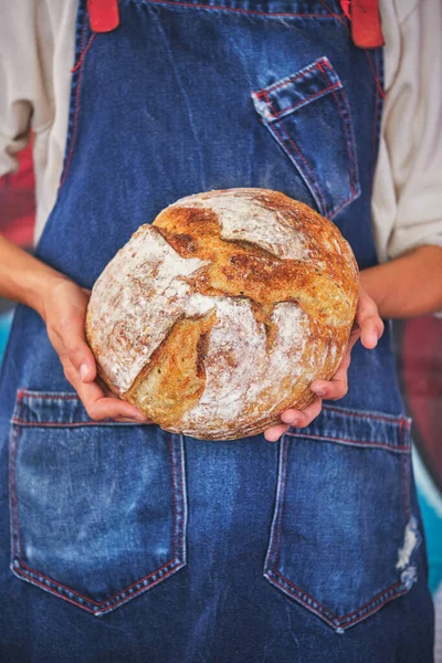 Photo Detail Female Hands Holding Artisan Bread Blue Kitchen Apron — Stock Photo, Image