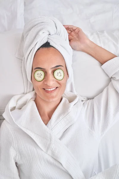 Relaxed Female Bathrobe Towel Cucumber Slices Eyes Resting Bed Skincare — Stock Photo, Image