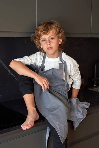 Adorable Barefoot Boy Curly Hair Apron Looking Camera While Sitting — Stock Photo, Image