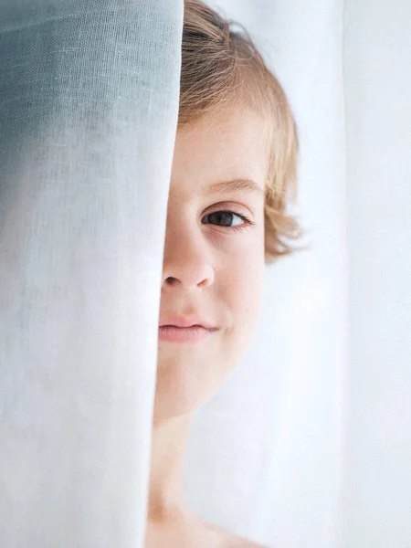 Crop Boy Blond Hair Peeking Out Curtain Looking Camera — Stock Photo, Image