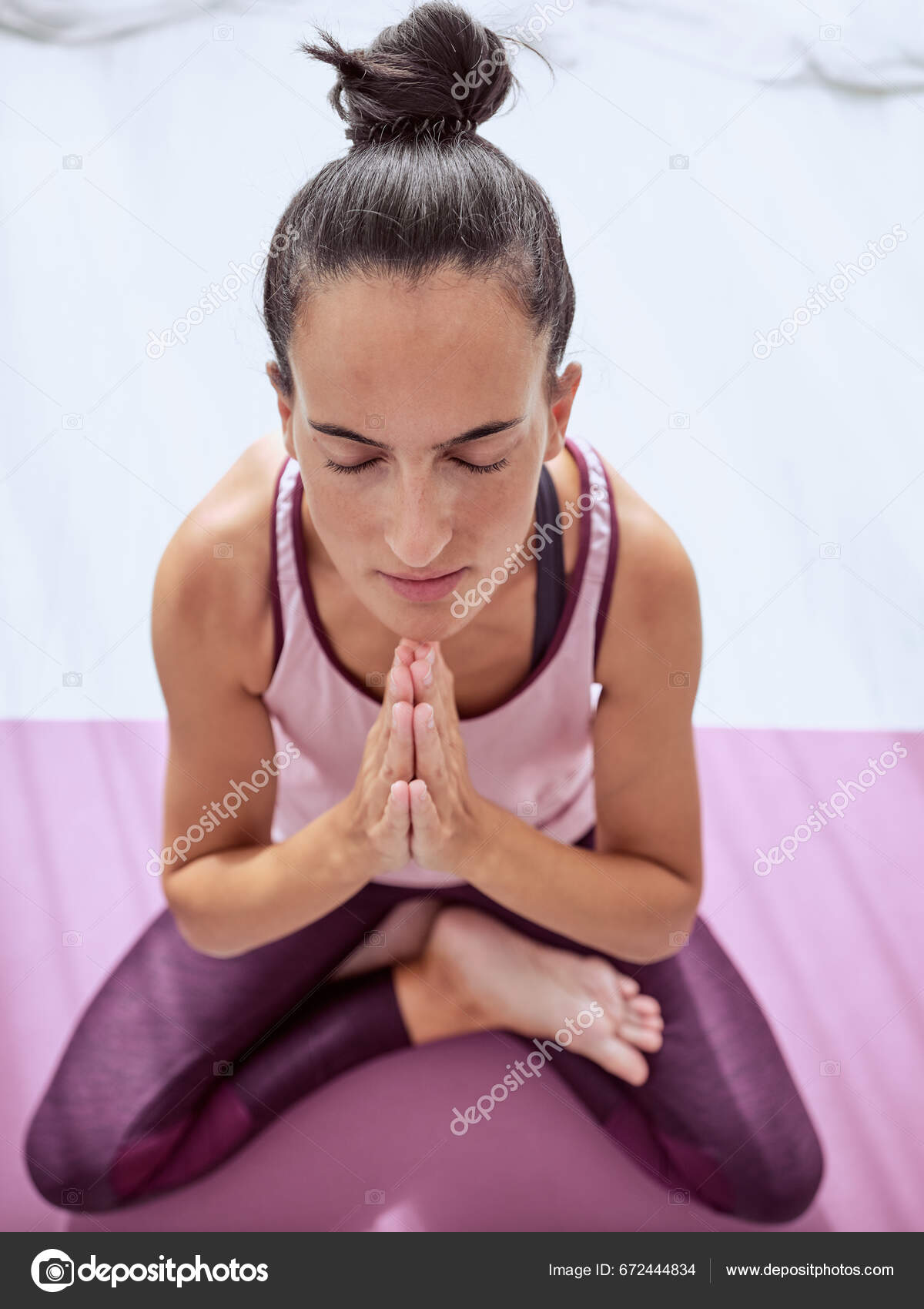 Full length shot of middle aged sporty woman sitting in lotus pose while  meditating on yoga mat Stock Photo - Alamy