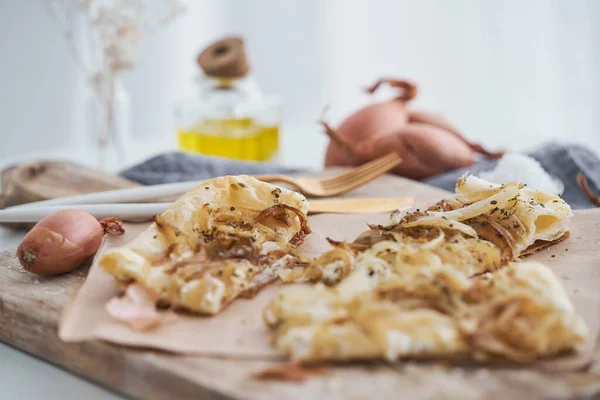 Slices Tasty Freshly Baked Puff Pastry Onion Tart Served Parchment — Stock Photo, Image