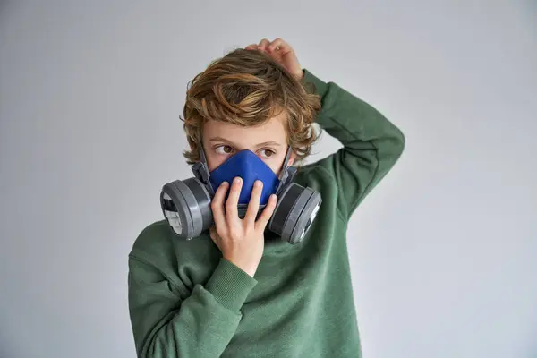 Thoughtful Little Boy Blond Hair Casual Clothes Putting Protective Respirator — Stock Photo, Image