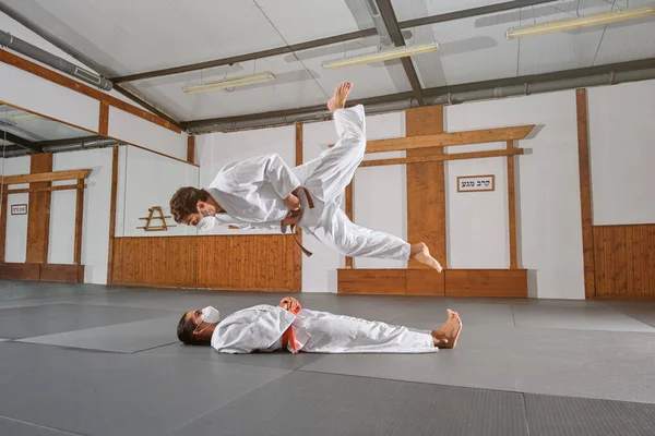 Two People Mask Kimono Practicing Krav Maga While One Jumps — Stock Photo, Image