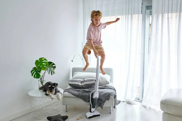 Barefoot Boy Leaping Chair While Tidying Floor Table Schnauzer Dog — Stock Photo, Image