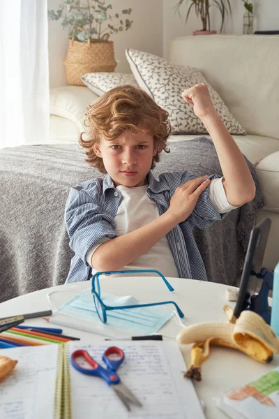 Nespokojeni Před Dospívající Chlapec Ukazuje Svaly Mračení Při Sezení Stolu — Stock fotografie