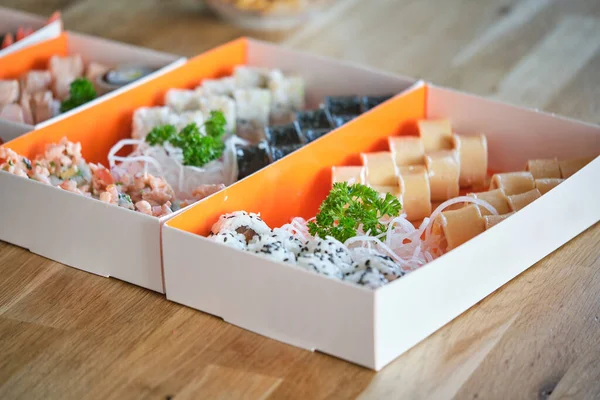 Assorted Sushi Rolls Different Fresh Fish Served Cardboard Boxes Greens — Stock Photo, Image