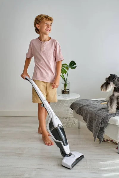 Full Body Barefoot Boy Smiling Looking Away While Using Vacuum — Stock Photo, Image