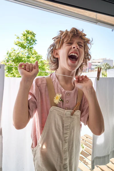 Excited Preteen Boy Pegs Hair Yelling Grasping Clothesline While Playing — Stock Photo, Image