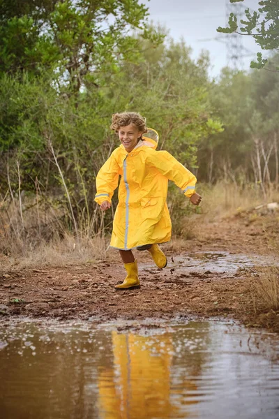 Little Charming Boy Yellow Raincoat Rubber Boots Running Dirty Puddle — Stock Photo, Image