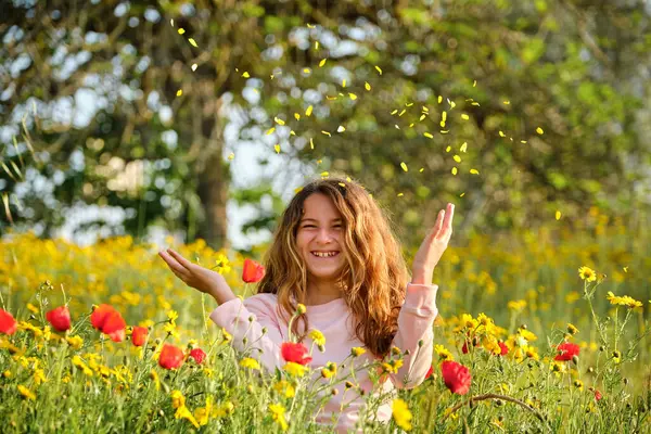Optimistisch Meisje Glimlachen Gooien Bloemblaadjes Lucht Terwijl Ontspannen Bloeiende Weide — Stockfoto