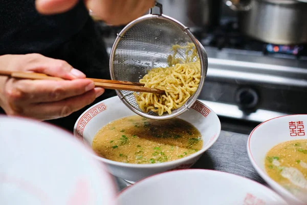 Crop Anonymous Chef Chopsticks Putting Noodles Bowl Bouillon While Serving — Stock Photo, Image
