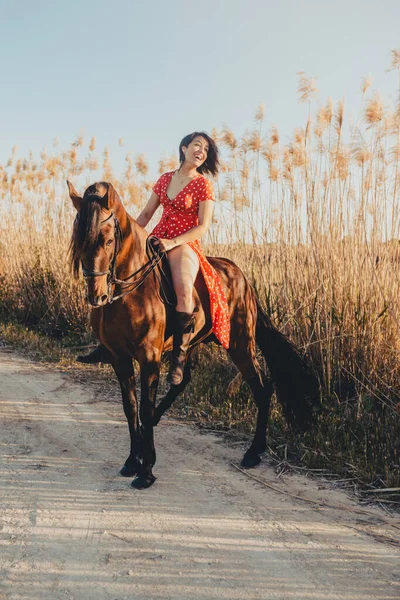 Young Female Red Dress Smiling Looking Camera While Sitting Horse — Stock Photo, Image
