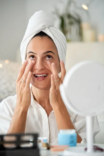 Delighted Female Soft Towel Turban Head Applying Moisturizing Facial Skin — Stock Photo, Image