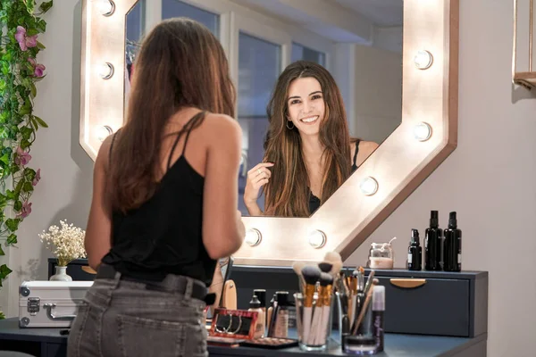 Delighted Young Female Brunette Touching Hair While Looking Mirror Beauty — Stock Photo, Image