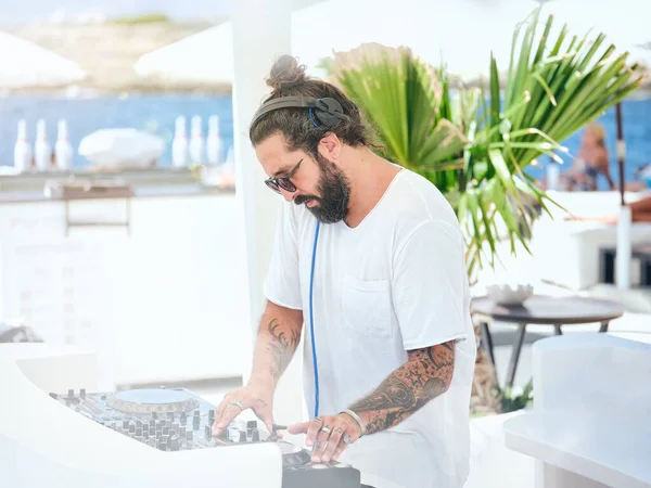 Side View Bearded Tattooed Male White Shirt Headphones Adjusting Sound — Stock Photo, Image