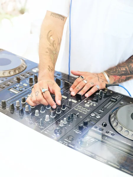 Unrecognizable Tattooed Male White Shirt Using Controller Adjust Music Sound — Stock Photo, Image