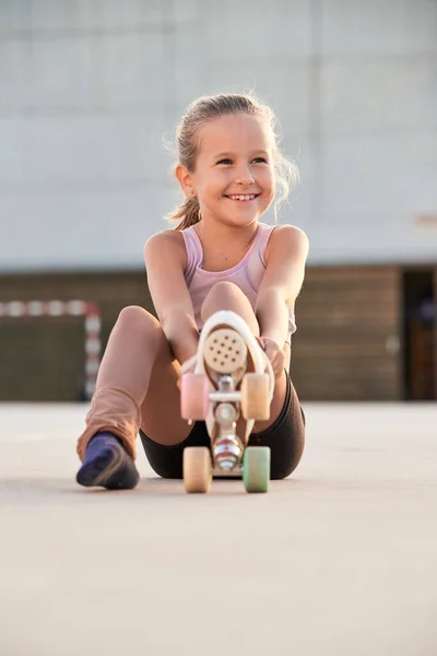 Pełne Ciało Uśmiechniętego Dziecka Sportowego Wrotkach Odwracając Wzrok Uśmiechem Siedząc — Zdjęcie stockowe