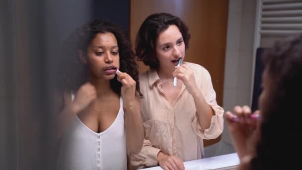 Aydınlanmış Banyoda Dişlerini Fırçalarken Siyah Saçlı Aynaya Bakan Çok Kültürlü — Stok video