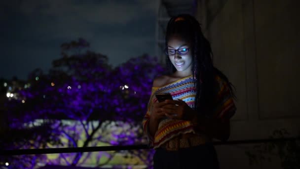 Афроамериканська Жінка Сидить Кафе Ввечері Спілкується Соціальних Мережах Через Смартфон — стокове відео