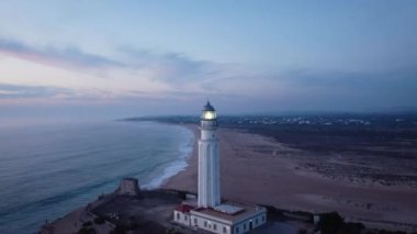 İspanya 'nın Cadiz ilindeki kayalık deniz kıyısındaki eski Trafalgar deniz feneri kulesinin insansız hava aracı görüntüsü