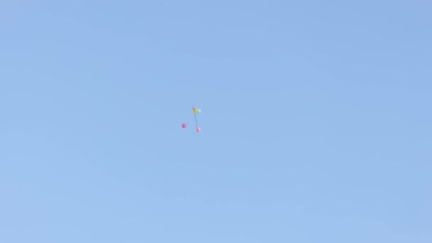 Real time heap of colorful balloons soaring high in air on cloudless blue sky on sunny weather on summer day