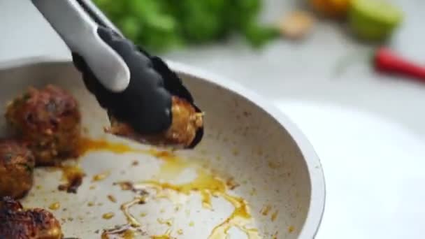 Crop Anonymous Female Tongs Placing Fried Meatballs White Ceramic Plate — Stock Video