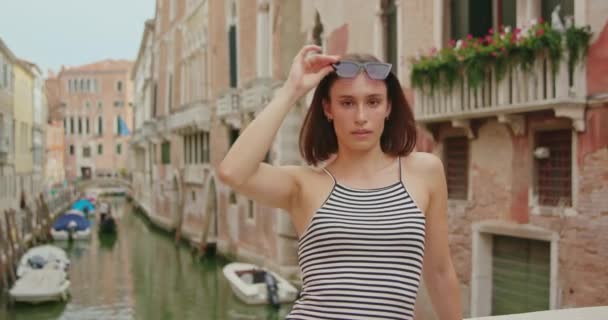 Cheerful Young Woman Striped Top Sunglasses Leaning Border Footbridge Canal — Stock Video