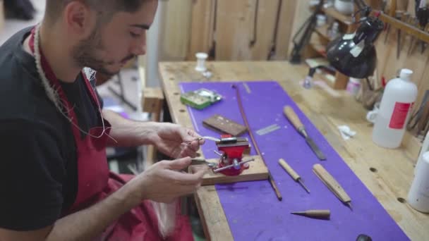 Skilled Artisan Luthier Using Chisel While Making Violin Bow Workshop — Stockvideo