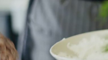 Geleneksel İtalyan ossobuco pişirirken çiğ dana inciğini un ile kaplayan isimsiz bir kadının gerçek zamanlı yüksek açılı görüntüsü.
