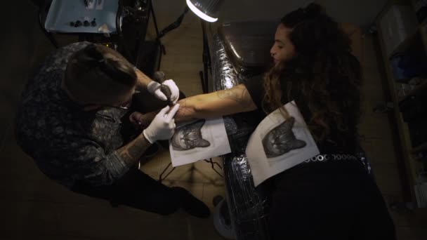 Татуировщик Делает Татуировку Предплечье Молодой Женщины Студии — стоковое видео