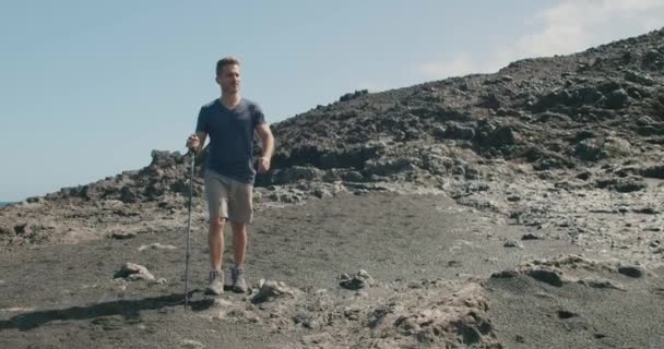Tracking Shot Mature Man Casual Clothes Walking Stick Hiking Volcanic — Video