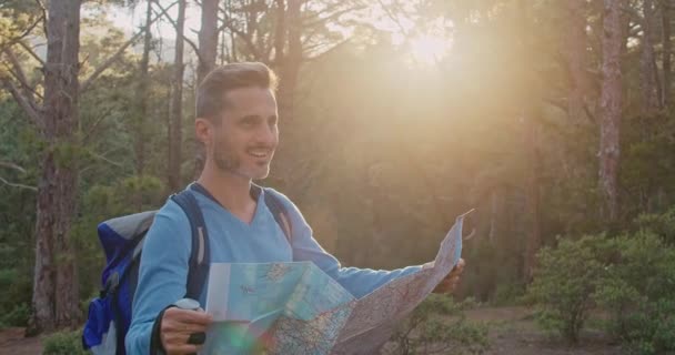 Człowiek Plecakiem Kijem Chodzenia Badając Papierową Mapę Podczas Wędrówki Lesie — Wideo stockowe