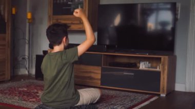 Evde video oyunu oynayan mutlu genç çocuğun portresi