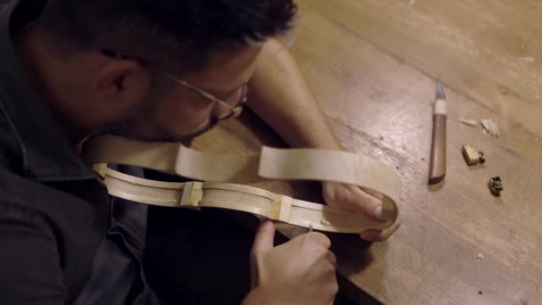 Yukarıdan Kesilen Odaklanmış Gözlüklü Bir Zanaatkar Tezgahta Oturuyor Kaburga Şekillendirerek — Stok video
