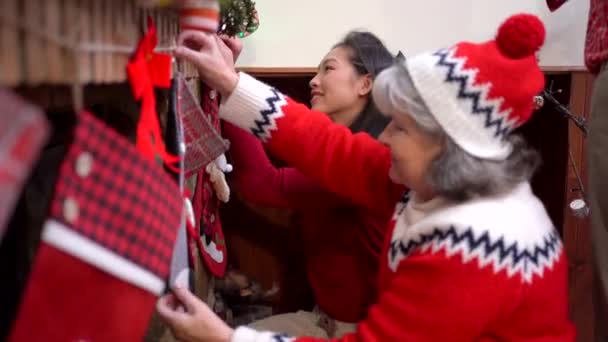 Side View Optimistic Multiracial Women Decorating Fireplace Stocking While Preparing — Stock Video