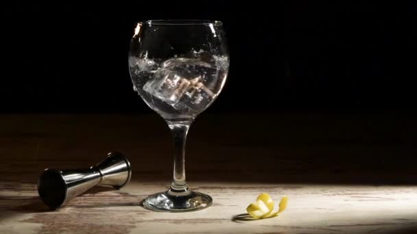 Jégkockákat Öntő Személy Egy Pohár Gin Tonikba Citrommal Jiggerrel Asztalon — Stock videók