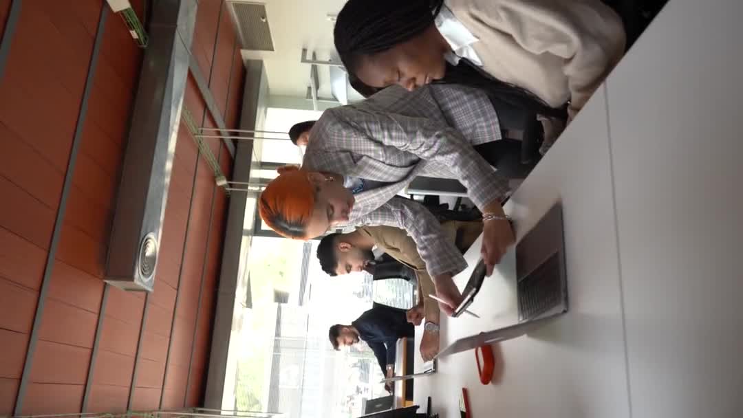 Különböző Vidám Munkatársak Csoportja Asztalhoz Laptoppal Megvitatva Projektet Miközben Együtt — Stock videók