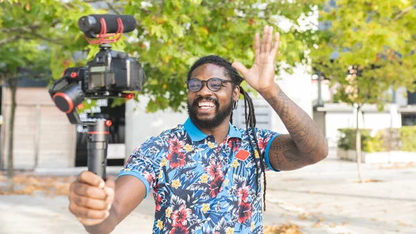 African American Blogger Dreadlocks Eyeglasses Waving Hands While Shooting Video — Stock Photo, Image