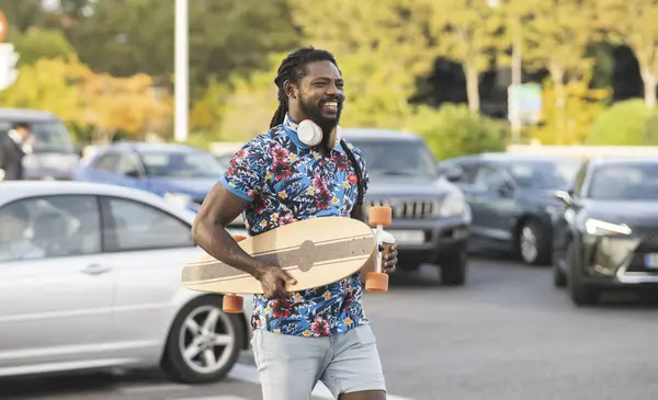 Cheerful African American Male Wireless Headphones Carrying Longboard Takeaway Coffee — Stock Photo, Image