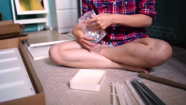 Crop Faceless Female Pouring Assorted Fittings Elements Box While Preparing — Stock Video