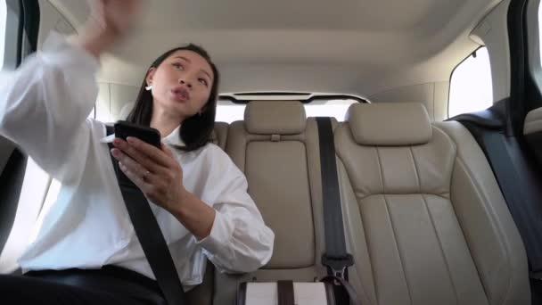 Wanita Asia Muda Yang Menggunakan Telepon Saat Naik Taksi Siang — Stok Video