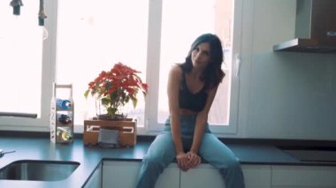 Genç esmer, seksi kadın odada poz veriyor.