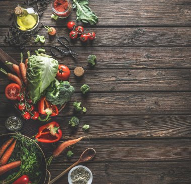Organik sebzeli gıda arka planı, sağlıklı malzemeler ve siyah ahşap masadaki mutfak aletleri. Üst Manzara. Boşluğu kopyala.