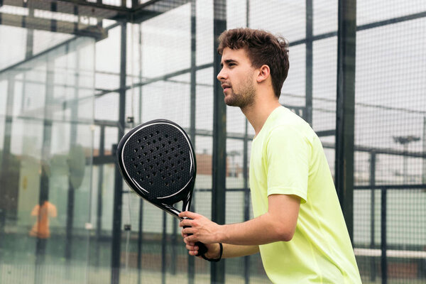Young man ready to play paddle tennis