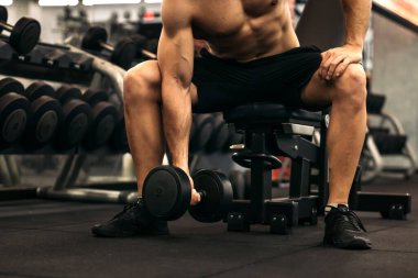 Dambılı kaslı adam antrenman kolu.