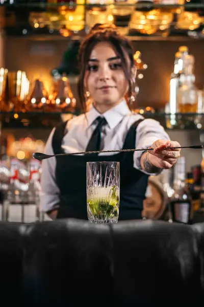 Stock image Female bartender preparing a cocktail in a traditional cocktail bar