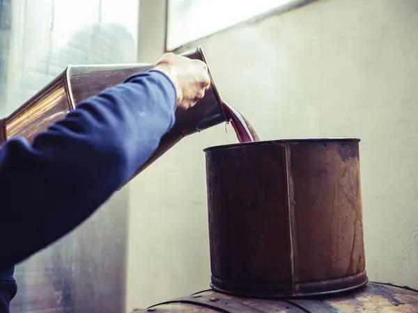 stock image Anonymous person in the traditional preparation of the Palo de Mallorca liqueur, a dark, dense drink with a distinct aroma, made through the hydroalcoholic maceration of cinchona and gentian roots, finished with caramelized sugar