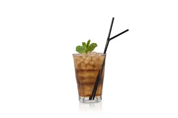 stock image A crystal-clear glass showcases a refreshing iced cocktail garnished with a sprig of mint, complete with two straws for sipping